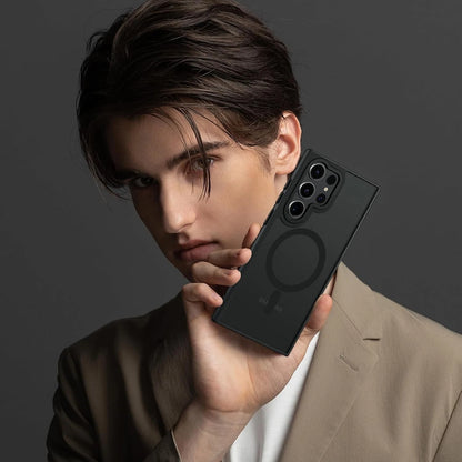 Black frosted Samsung Galaxy S25 Ultra case with MagSafe ring, held by person in beige blazer and white shirt.